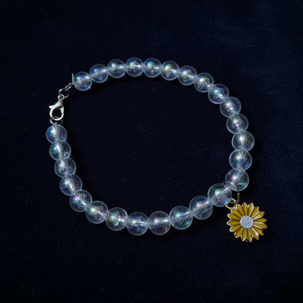 Clear AB aurora bead bracelet with sunflower charm on dark background
