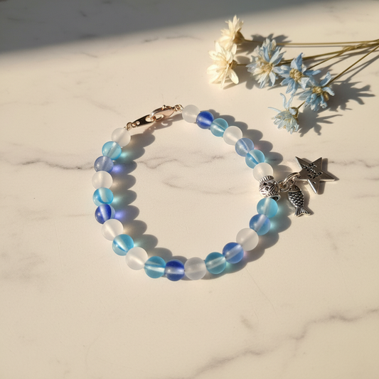 Blue white aurora glow crystal bracelet with star and fish charm lifestyle