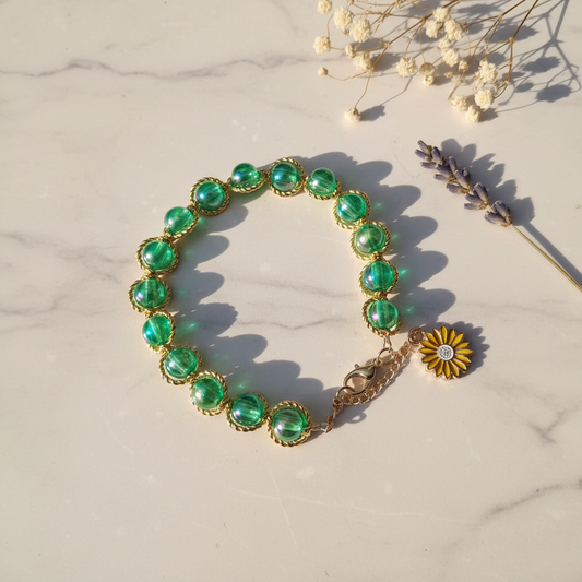 Green iridescent pearl bezel bracelet with sunflower charm lifestyle