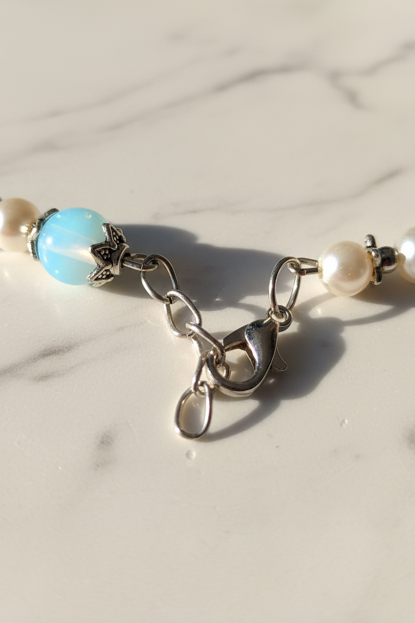 Adjustable clasp detail of handcrafted bead bracelet on marble background