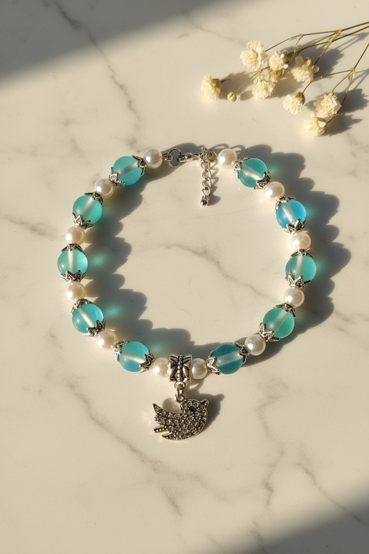 Handcrafted bead bracelet with charm on marble lifestyle background
