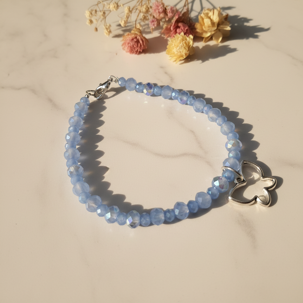 Periwinkle blue crystal rondelle bracelet with open butterfly charm lifestyle