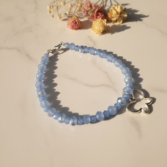 Periwinkle blue crystal rondelle bracelet with open butterfly charm lifestyle
