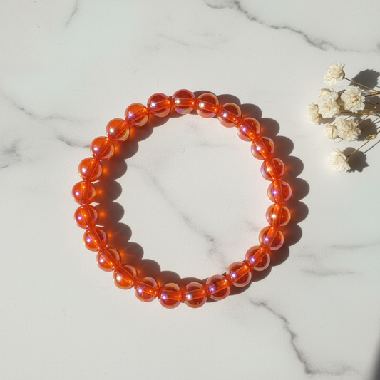 Translucent orange red aurora iridescent bead stretch bracelet lifestyle